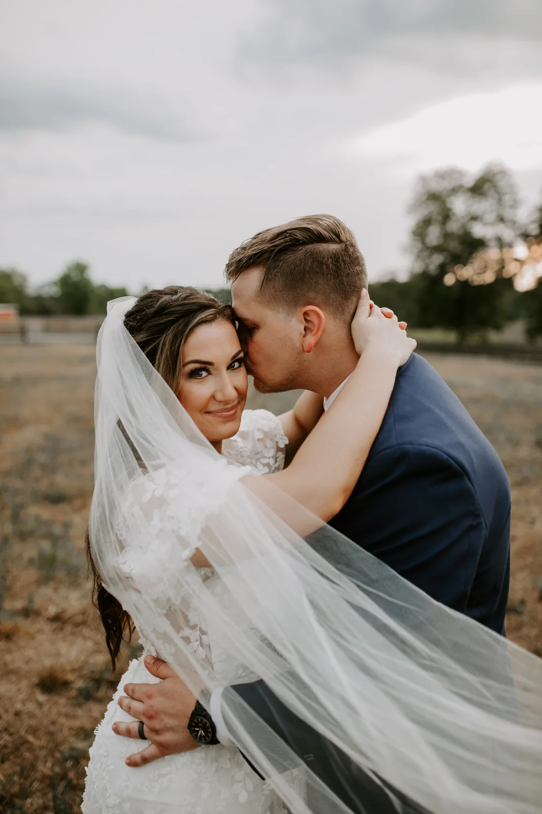 Bride and groom embracing outdoors