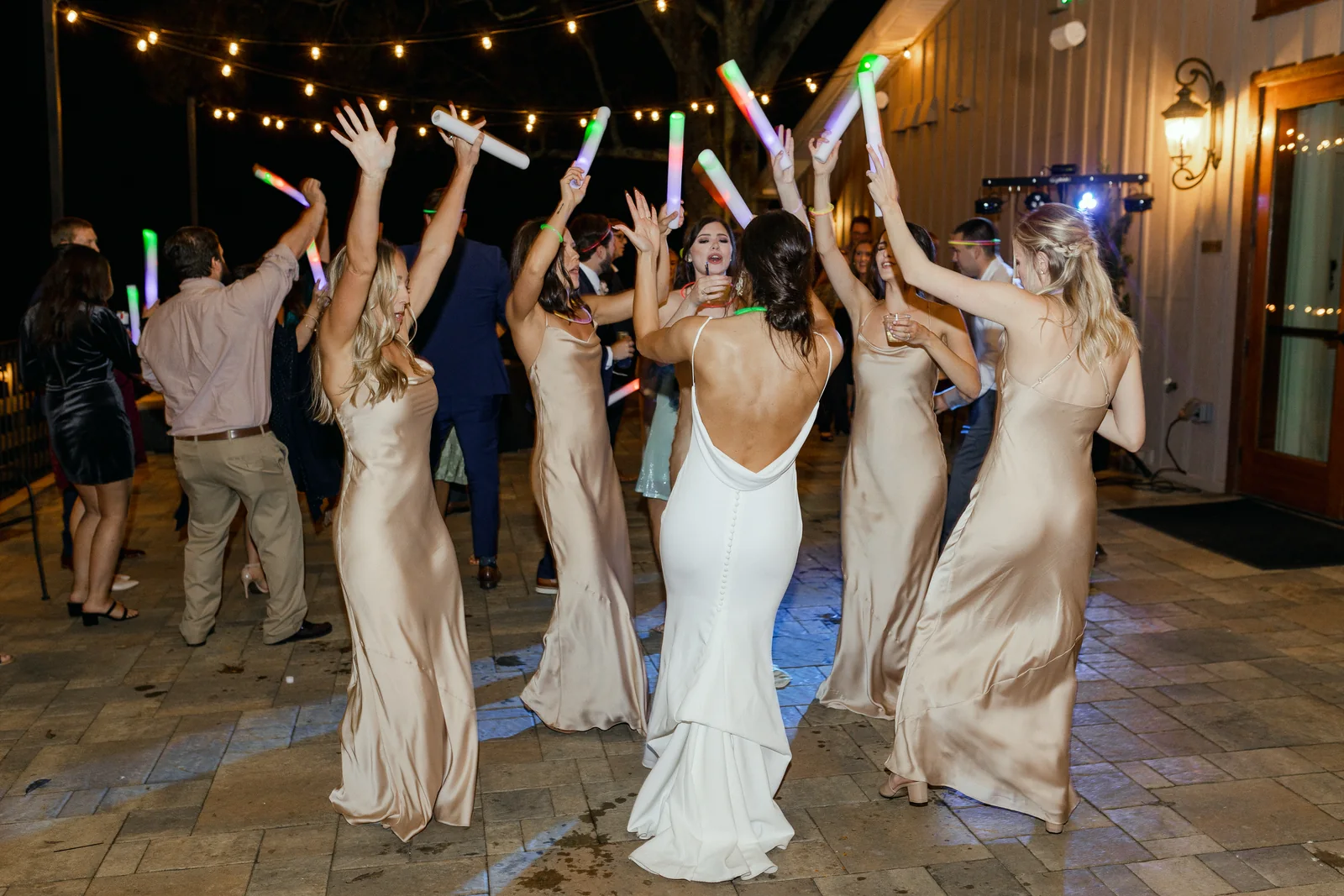 Wedding guests celebrating on the reception dance floor